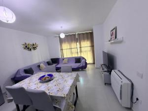 a living room with a table and a couch at Luxurious seaside apartment in Sakës +2 photos