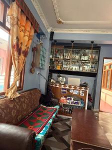 a living room with a couch and a table at Hotel River View in Syābru Bensi