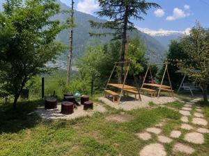 a park with a picnic table and a swing at Peakaboo Manali in Manāli