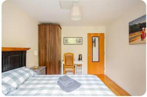a bedroom with a bed and a desk with a chair at Sequoia Tree in Belfast