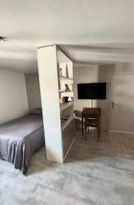 a bedroom with a bed and a flat screen tv at Central Studio - Port & Lices walkable - Parking in Saint-Tropez