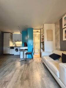a living room with a couch and a table at Central Studio - Port & Lices walkable - Parking in Saint-Tropez
