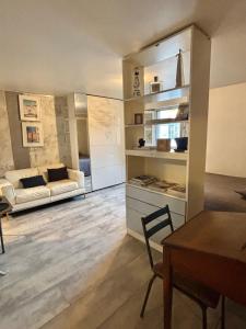 a living room with a couch and a table at Central Studio - Port & Lices walkable - Parking in Saint-Tropez +4 photos