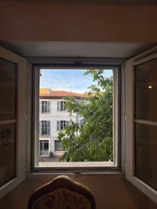 a window with a view of a building at Central Studio - Port & Lices walkable - Parking in Saint-Tropez