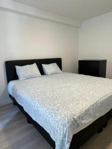 a bedroom with a large bed with two pillows at The Waves in Ostend