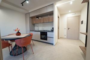 a kitchen with a table and chairs in a room at HERMES Luxury Home in Agrigento