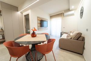 a living room with a table and chairs and a couch at HERMES Luxury Home in Agrigento