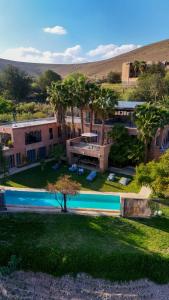 an aerial view of a house with a swimming pool at Villa bord du lac takerkoust marrakech , 9 Suites de Luxe & événementiel in Wawizelt