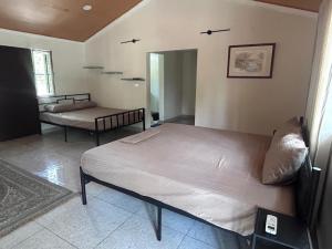 a bedroom with two beds in a room at Nadaa Organic Farms in Khammam