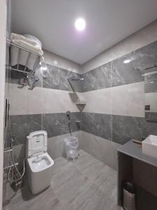 a bathroom with a toilet and a sink at Touch wood guest house in Dharmsāla