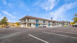 a large building with cars parked in a parking lot at Studio 6 Elko, NV in Elko