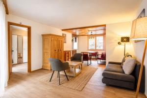 a living room with a couch and a table at Hotel Restaurant Jungfrau in Lauterbrunnen +42 photos