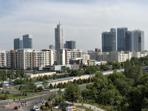 a city with a highway in front of buildings at Tashkent City View Apartments in Tashkent