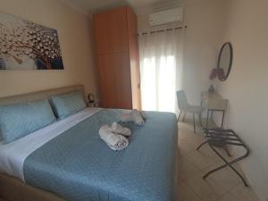 a bedroom with a bed with towels on it at BlackGeorge Apartment Mountain View in Ioannina