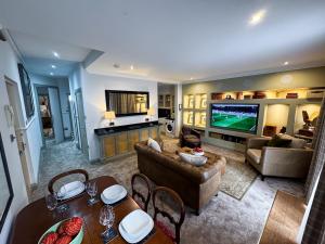 a living room with a couch and a tv at 2 Bed Ground floor Apartment with parking in Auchterarder