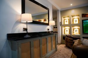 a living room with a mirror and a television at 2 Bed Ground floor Apartment with parking in Auchterarder