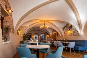 a restaurant with blue chairs and tables at Hotel Casa Wagner in Sighişoara
