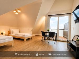 a bedroom with a bed and a table and chairs at Ort 245 in Ried im Innkreis