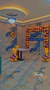 a room with a winnie the pooh mural and a table at sSS HOTEL & RESTURENT in Ahraurā Road