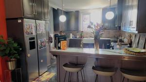 a kitchen with a counter with stools in it at Hilltop Villa Chez Coco in Rodney Bay Village