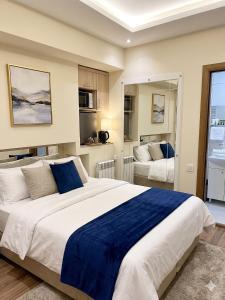 a bedroom with a large bed with a blue blanket at Moldavian Luxury in Chişinău