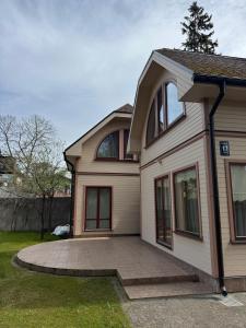 a large white house with a circular driveway at Saules home Jomas - early check in, late check out in Jūrmala