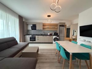 a living room with a couch and a table at DOCA Apartments 10 in Otopeni +5 photos