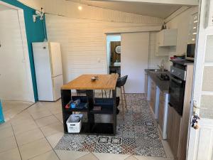 a small kitchen with a wooden table in it at Kay Yvette in Saint-Pierre