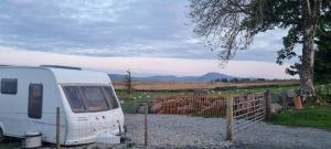 a white van parked next to a fence at Peaceful Private Haven in Frongoch