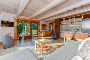 a living room with a couch and a table at VIP forest dreams villa 2 in Leliūnai