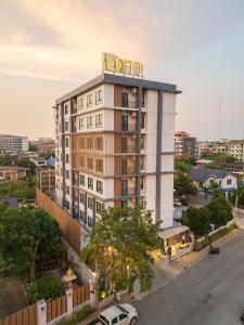 a building with a sign on top of it at Napa Hotel Ratchaburi in Ratchaburi