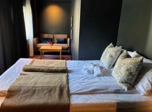 a bedroom with a large bed with towels on it at Bringenatten Hotell Nesbyen in Nesbyen +33 photos
