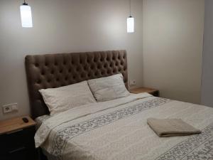 a bedroom with a large bed with two pillows at Воскресенская 12 Евро in Dnipro