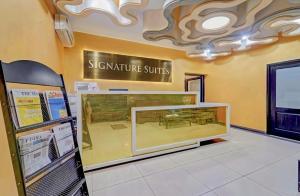 a restaurant with a display case in a store at Signature Suites Chennai in Chennai