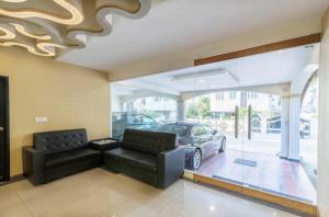 a living room with a couch and a car at Signature Suites Chennai in Chennai