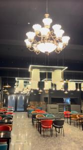 a large room with chairs and a chandelier at Nawabz Hotel in Karnal
