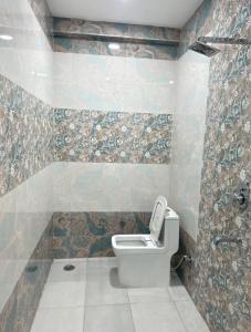 a bathroom with a toilet in a room at Nawabz Hotel in Karnal