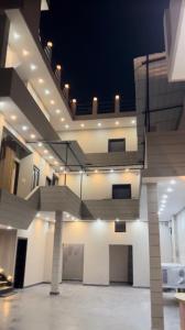 a large room with a staircase in the ceiling at Nawabz Hotel in Karnal +2 photos