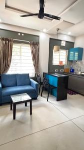 a living room with a blue couch and a table at G10 & 12 - Sabari Enclave Premium One bedroom Apartment in Trivandrum