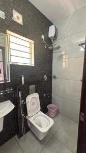 a bathroom with a toilet and a sink at G10 & 12 - Sabari Enclave Premium One bedroom Apartment in Trivandrum +23 photos