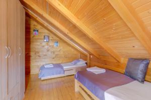 a room with two beds in a wooden cabin at Seaview Chalet in Herceg-Novi