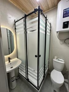 a bathroom with a toilet and a sink at Wings Zen in Bosteri +40 photos