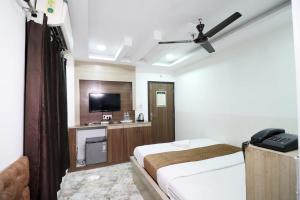a hotel room with two beds and a flat screen tv at Hotel best buy in Kolkata