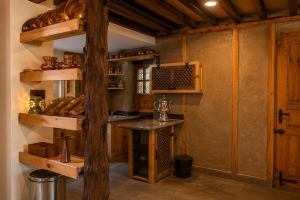 a kitchen with wooden shelves and a counter with bread at Shepherd Barn Pahalgam in Pahalgām