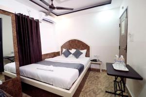 a bedroom with a bed and a desk in a room at Hotel best buy in Kolkata
