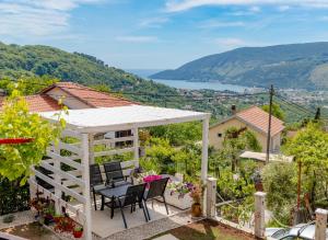 a patio with chairs and a white gazebo at Seaview Chalet in Herceg-Novi +19 photos