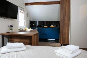 a bedroom with a bed and a desk with towels at Villa Bellevue Genève in Annemasse +175 photos