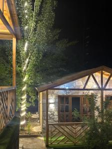 a house with a wooden door and string lights at Trivor resort in Hunza Valley