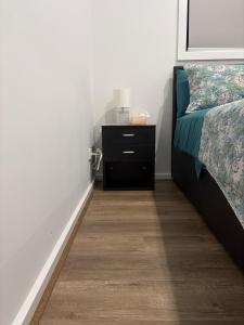 a bedroom with a bed and a dresser with a night stand at Private Room in Rockbank in Rockbank