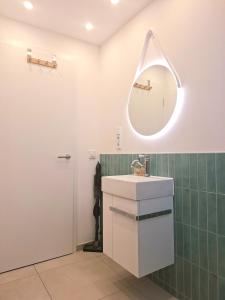 a bathroom with a sink and a mirror at Helle Dachgeschosswohnung, neu renoviert & ruhig in Wolfenbüttel +14 photos
